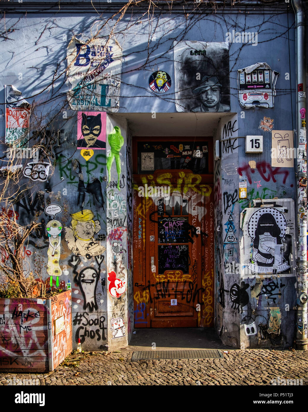 Image of an alleyway covered in stickers