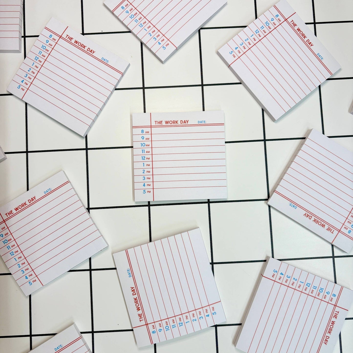 Simple sticky note pad labeled "The Work Day 8–5" styled on a clean desk