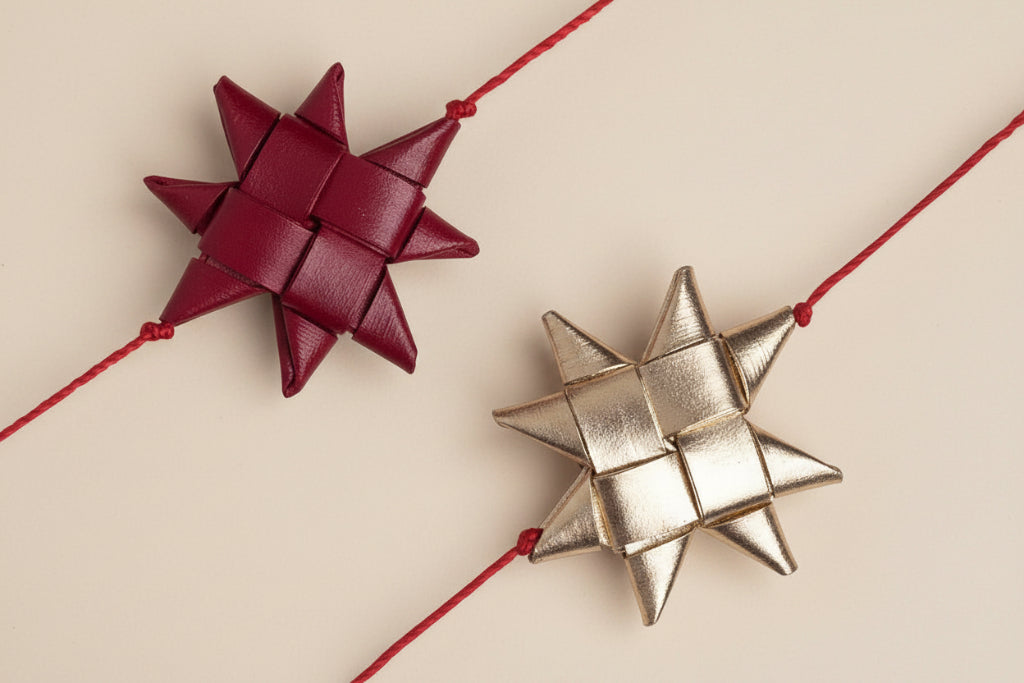 Two star-shaped decorative bows, one red and one gold, on a white background.
