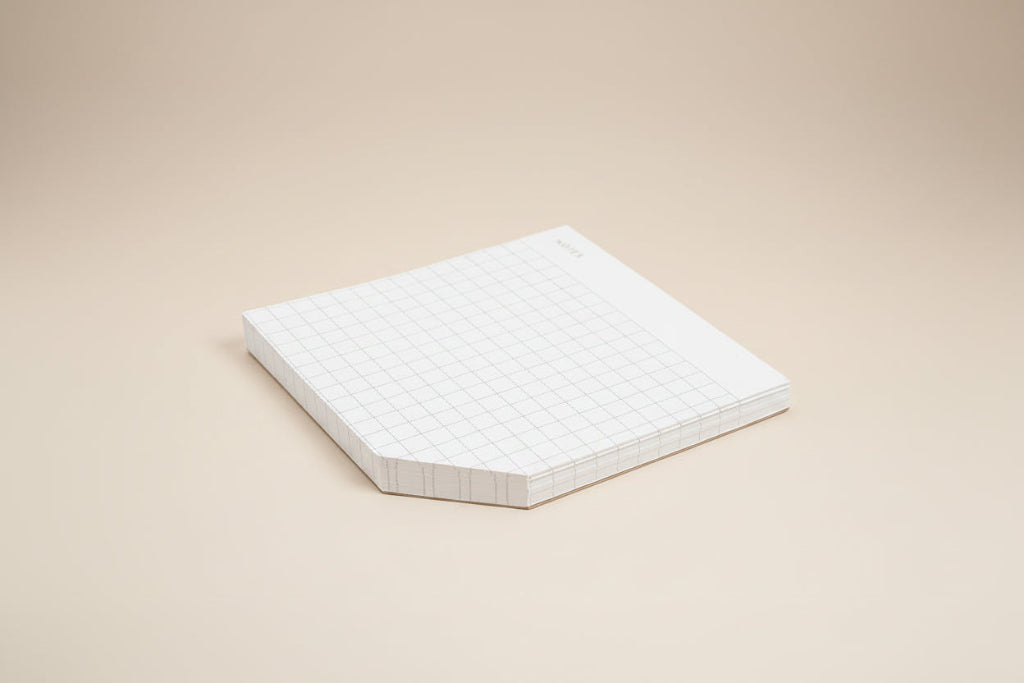White grid-patterned paper on a white background