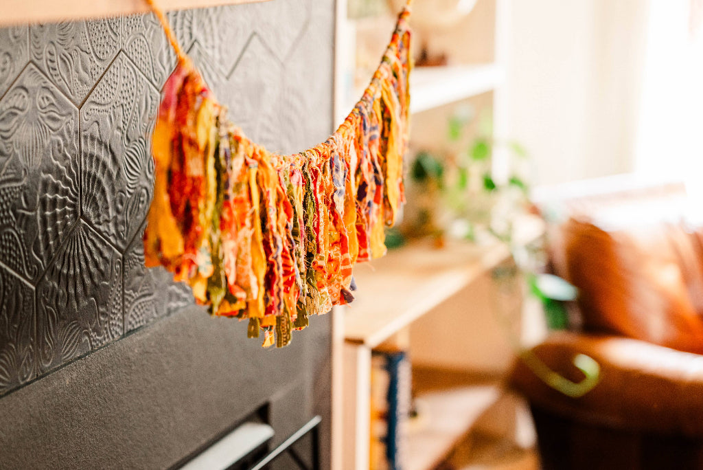 Colorful fabric hanging on a line against a blurred indoor background