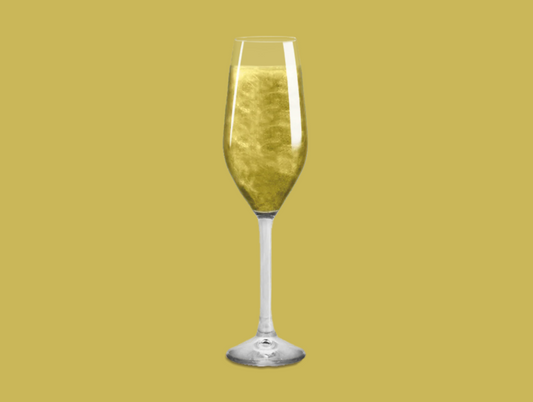 Glitter Bomb in a champagne flute, adding sparkle and color to the drink.