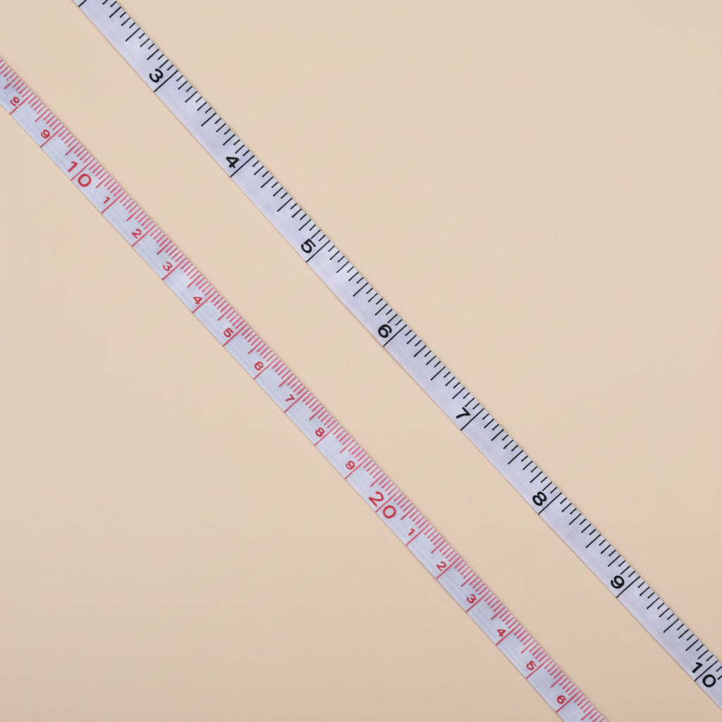 Measuring tape extended, showing inches clearly marked against the white tape