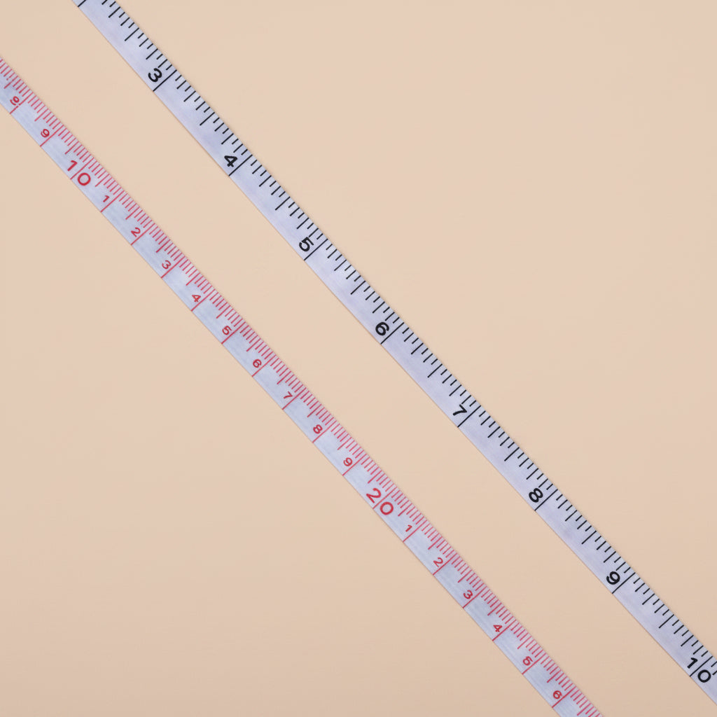 Extended measuring tape on a concrete surface