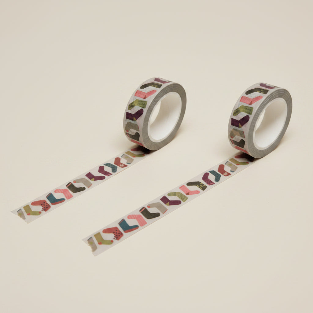 Two rolls of decorative sock or stocking washi tape with colorful patterns, on a white background