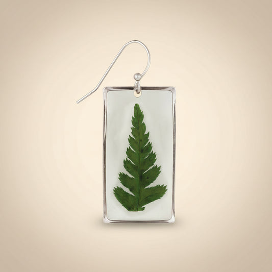 Earring with a pressed green leaf in a silver frame on a white background