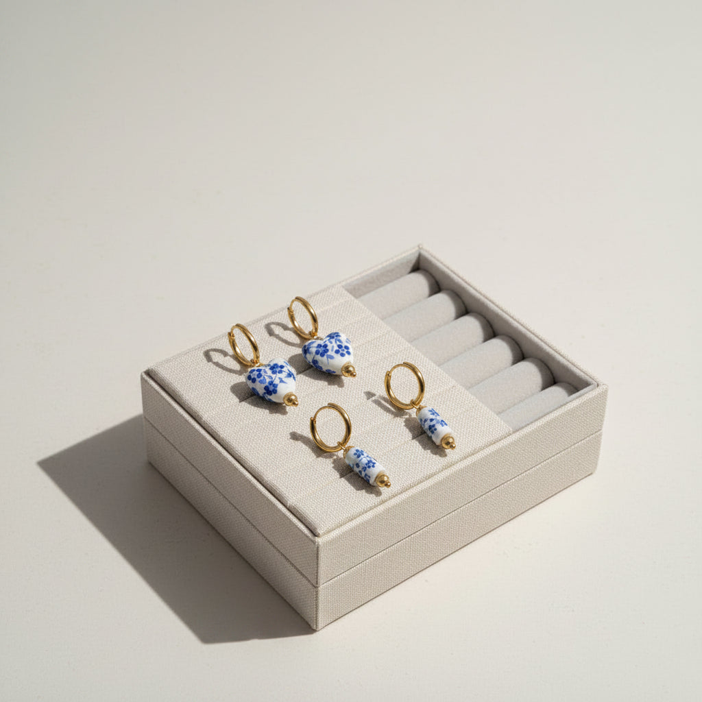 Set of four floral-themed earrings on a white background