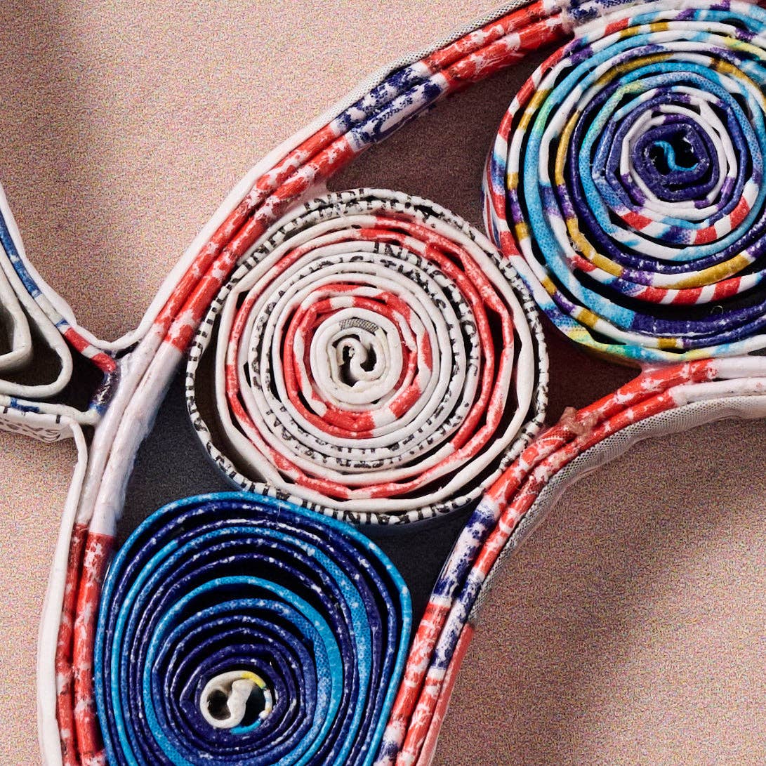 Colorful woven pattern on a wooden surface