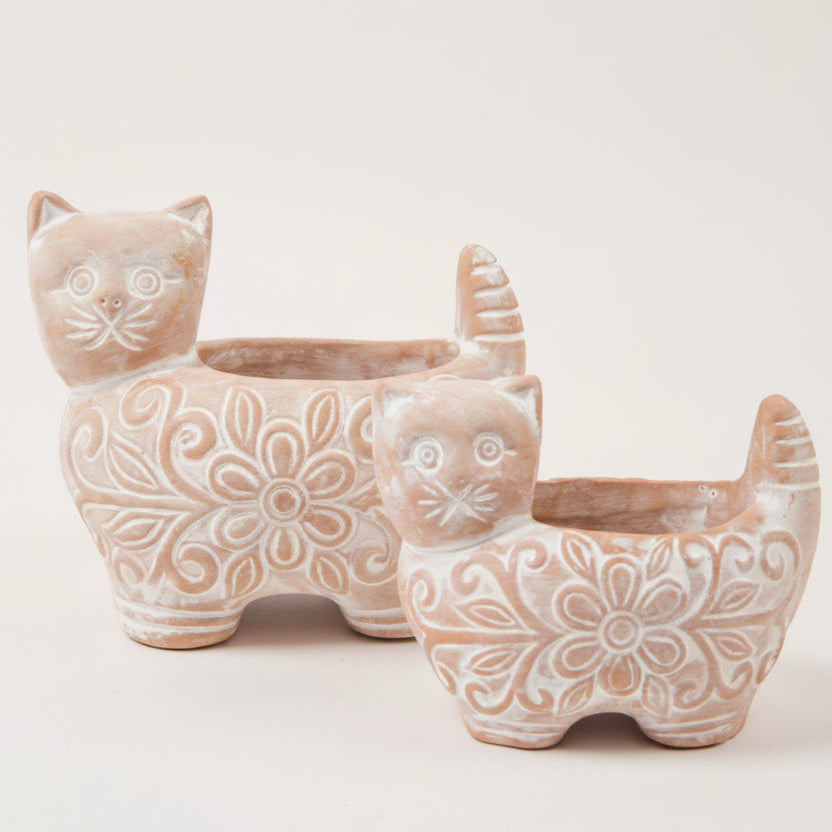 Ceramic cat-shaped planters with floral patterns on a white background