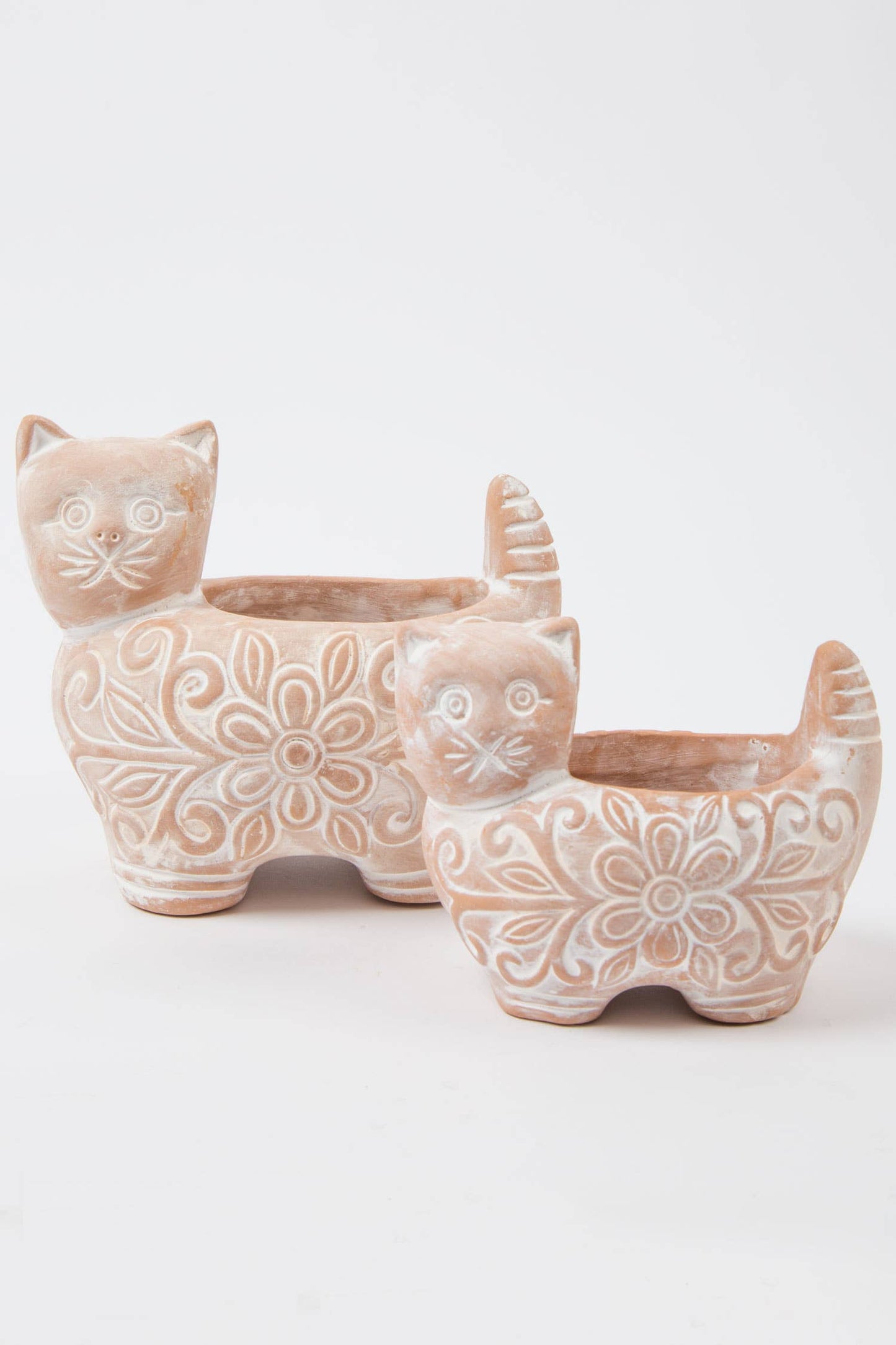Ceramic cat-shaped planters with floral patterns on a white background