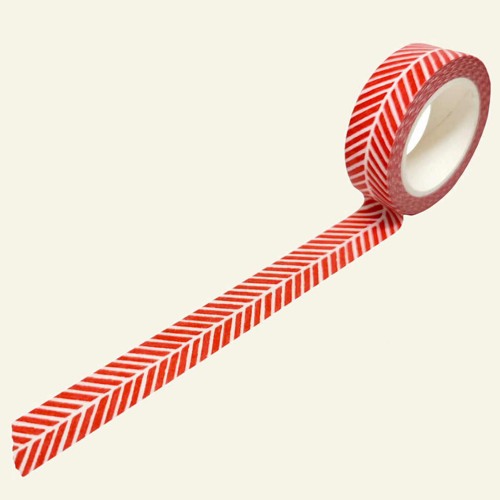 Roll of red and white herringbone striped washi tape on a white background