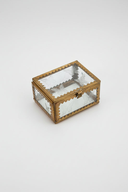 A small glass box with brass and etched stars