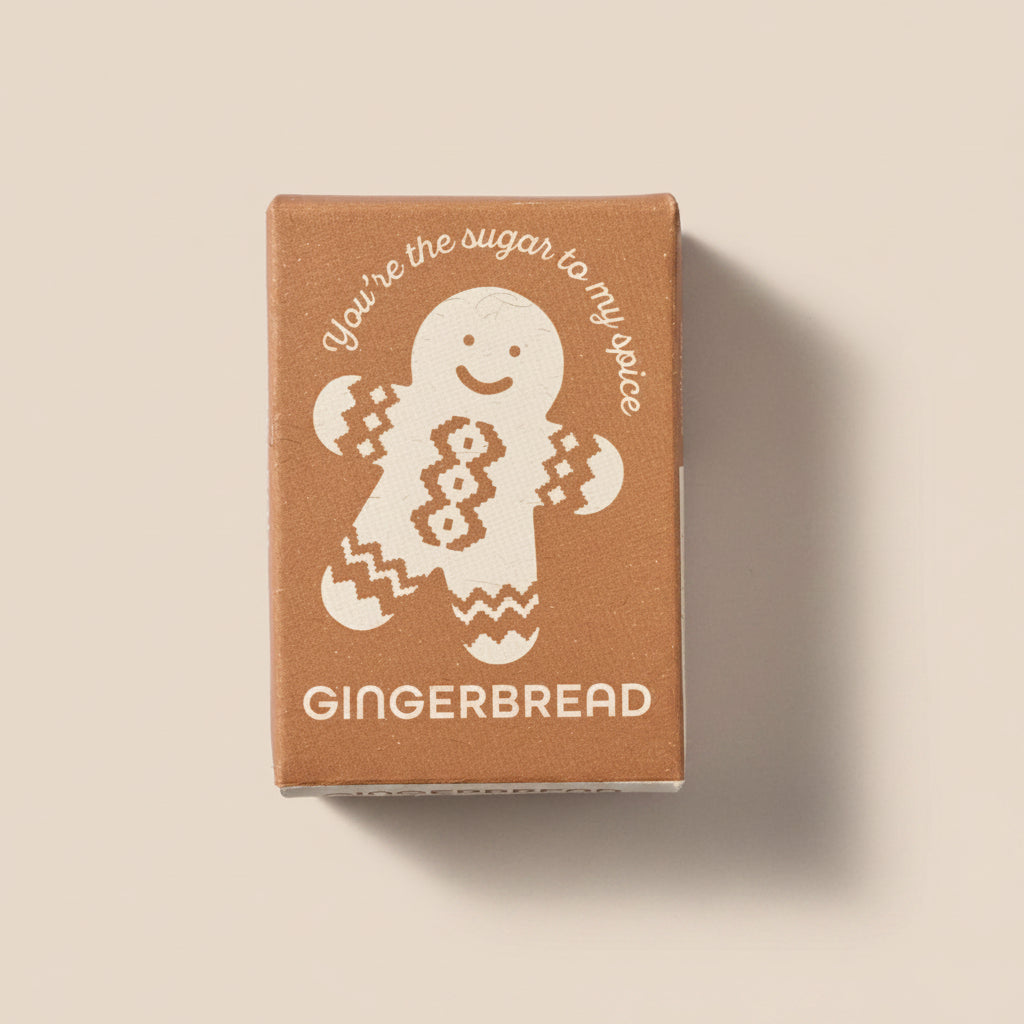 Gingerbread-themed product packaging with a gingerbread man illustration on a light gray background
