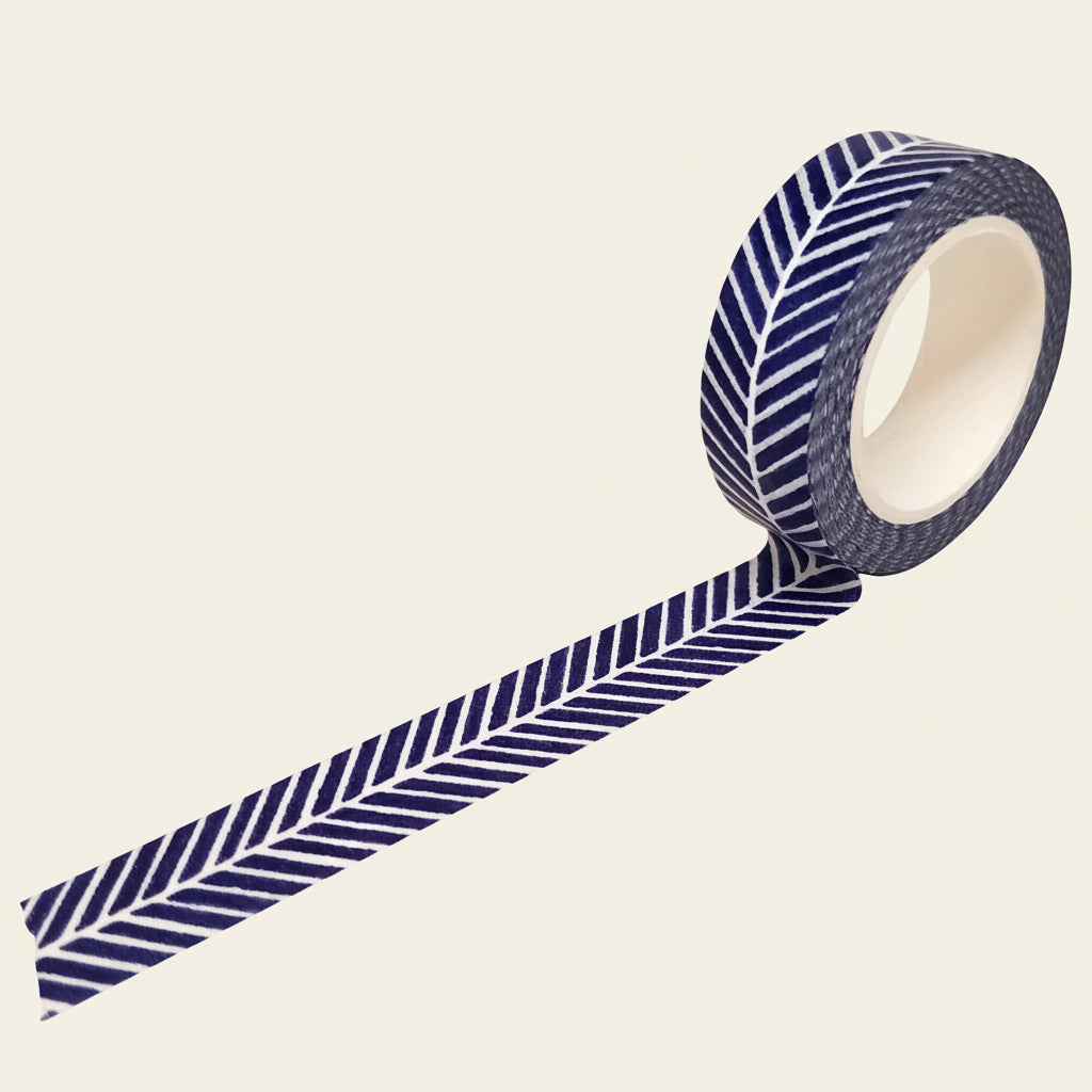 Roll of blue and white herringbone striped washi tape on a light beige background