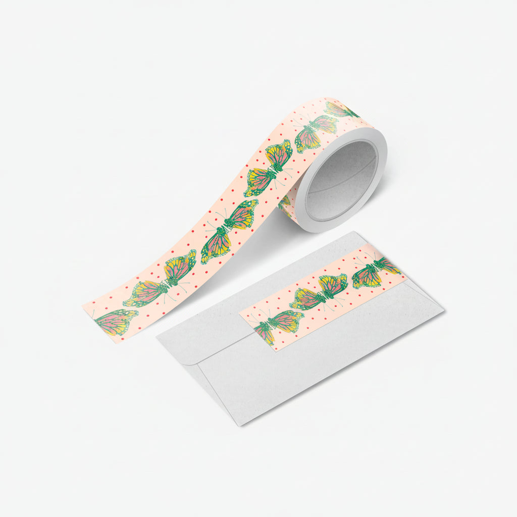 Close-up of monarch butterfly washi tape unspooled with vivid orange wings