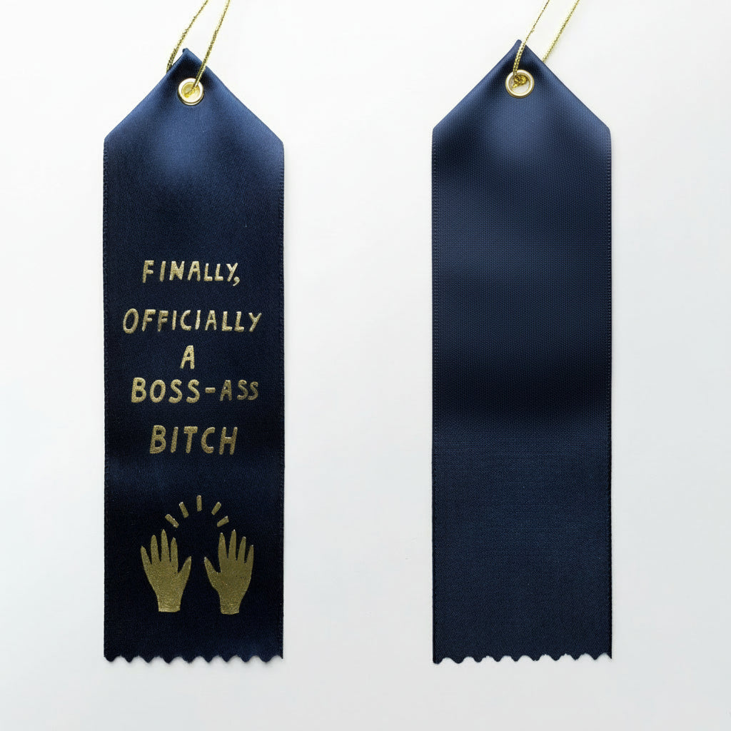 A navy blue award ribbon with gold foil text and design elements, featuring two versions shown side by side with one having a slot for a personalized message.