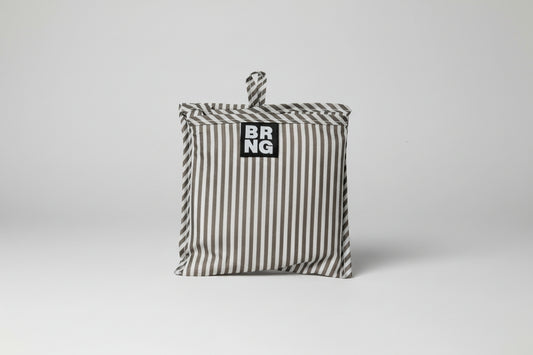 Close up of the Vickie Daily Shopper BRNG bag folded up on a white background.