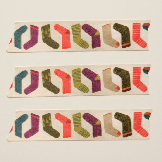 Close up view of three strips of the playful and fun stockings or socks on washi tape