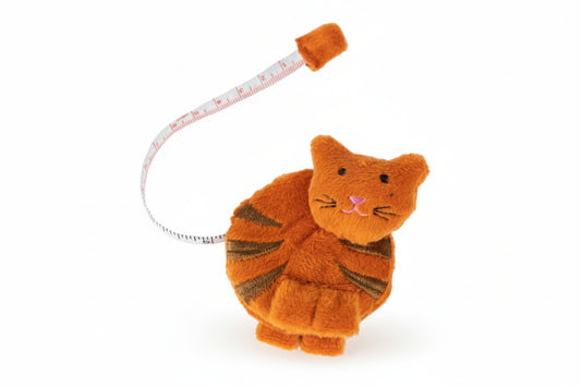 An orange fabric cat tape measurer on a white background