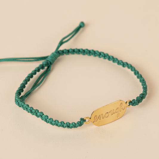 Empowering macrame bracelet with "You Are Enough" message, displayed on neutral background
