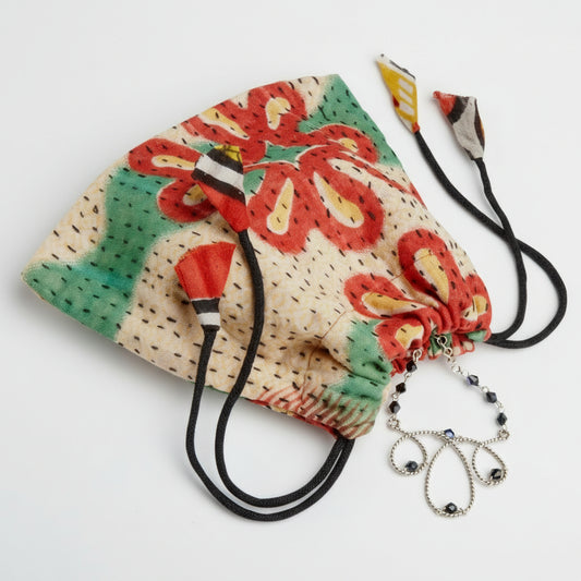 Gift bag holding a jewelry gift for a friend in this bright Recycled Sari gift bag