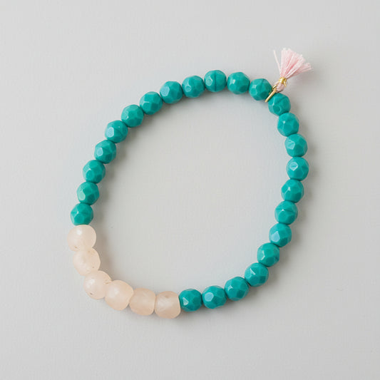 A collection of colorful beads on a bracelet with a tassel.