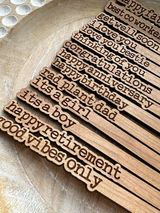 Laser-engraved plant sticks sealed for durability, ready for gifting.