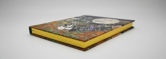 Close-up of embossed floral detail and shimmering gilded page edges