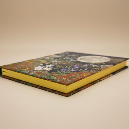 Close-up of embossed floral detail and shimmering gilded page edges