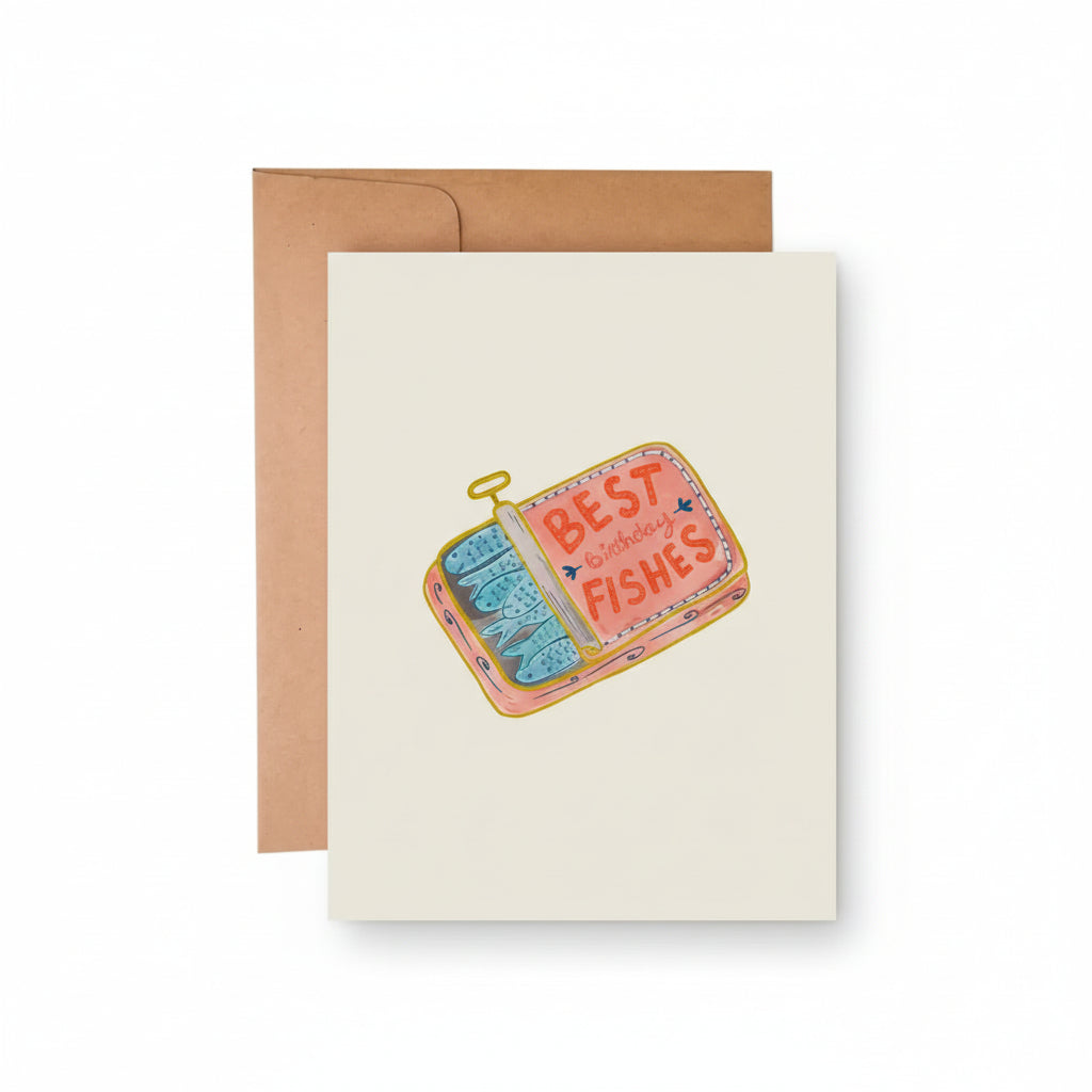 A greeting card with a colorful illustration of a sardine tin labeled 'BEST FISHES' on the front, accompanied by a kraft envelope on a white background.