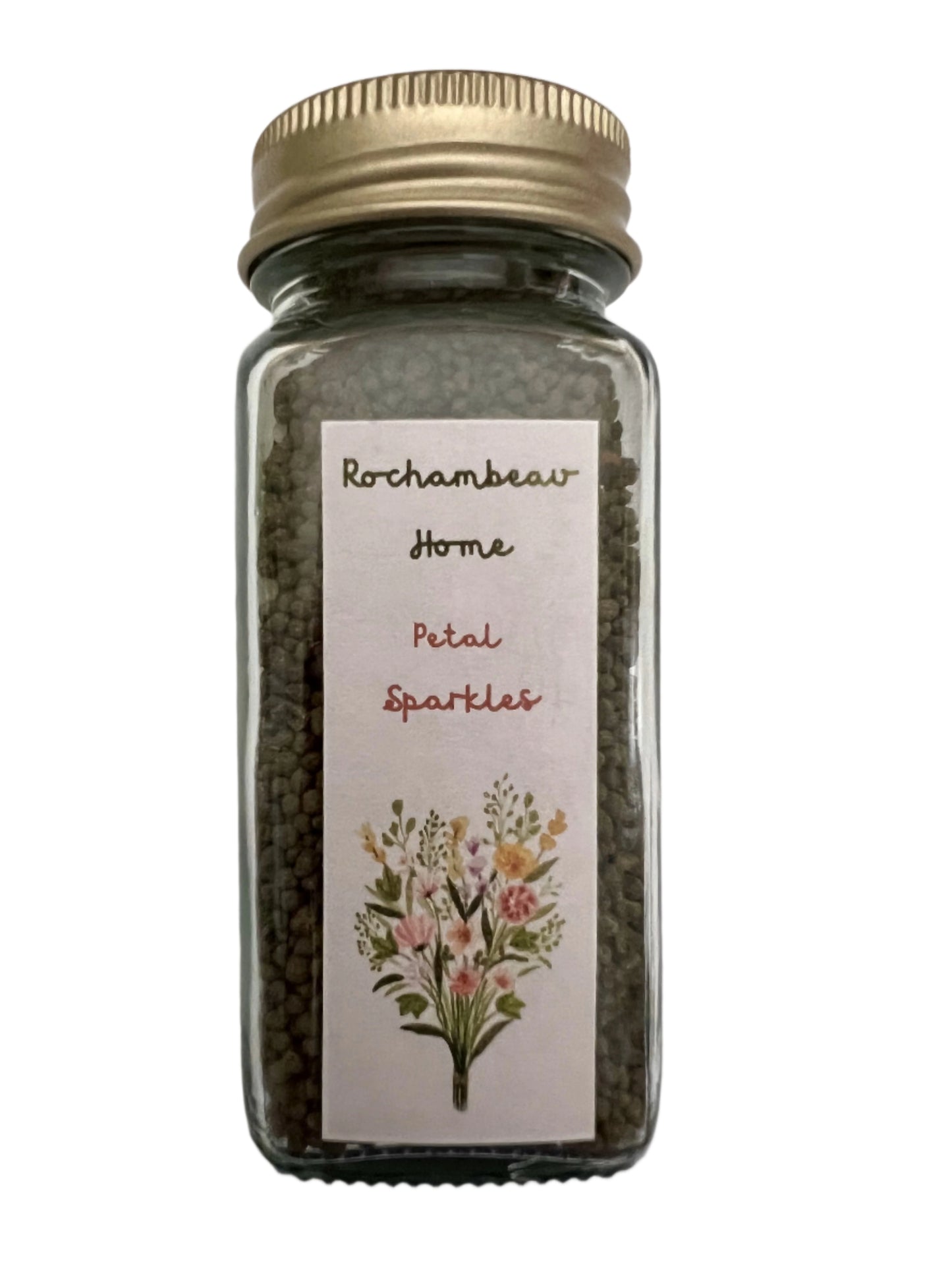 A 4 oz reusable glass jar labeled "Petal Sparkles," filled with a mix of wildflower seeds, featuring a gold tin lid—an eco-friendly gardening gift.