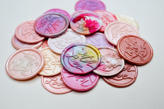 A close up view of the "With Love" wax seal stickers in the pink theme