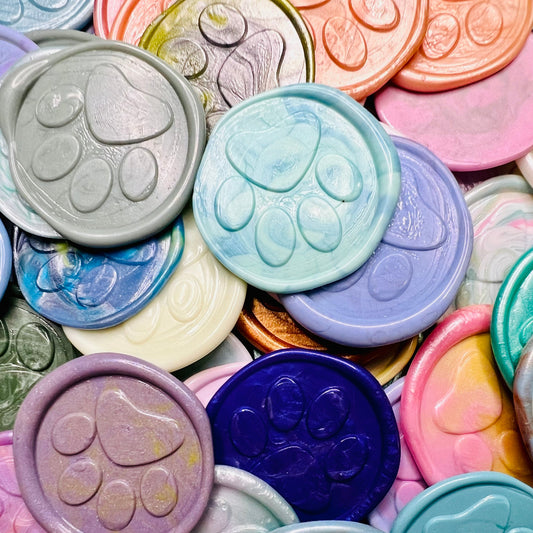 Close up view of various Little Print wax seal stickers from Rochambeau Home Gifts in various colors