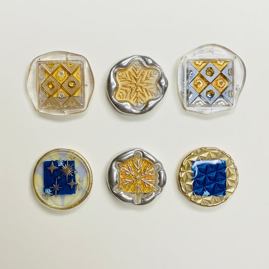Decorative magnets with geometric patterns on a patterned background