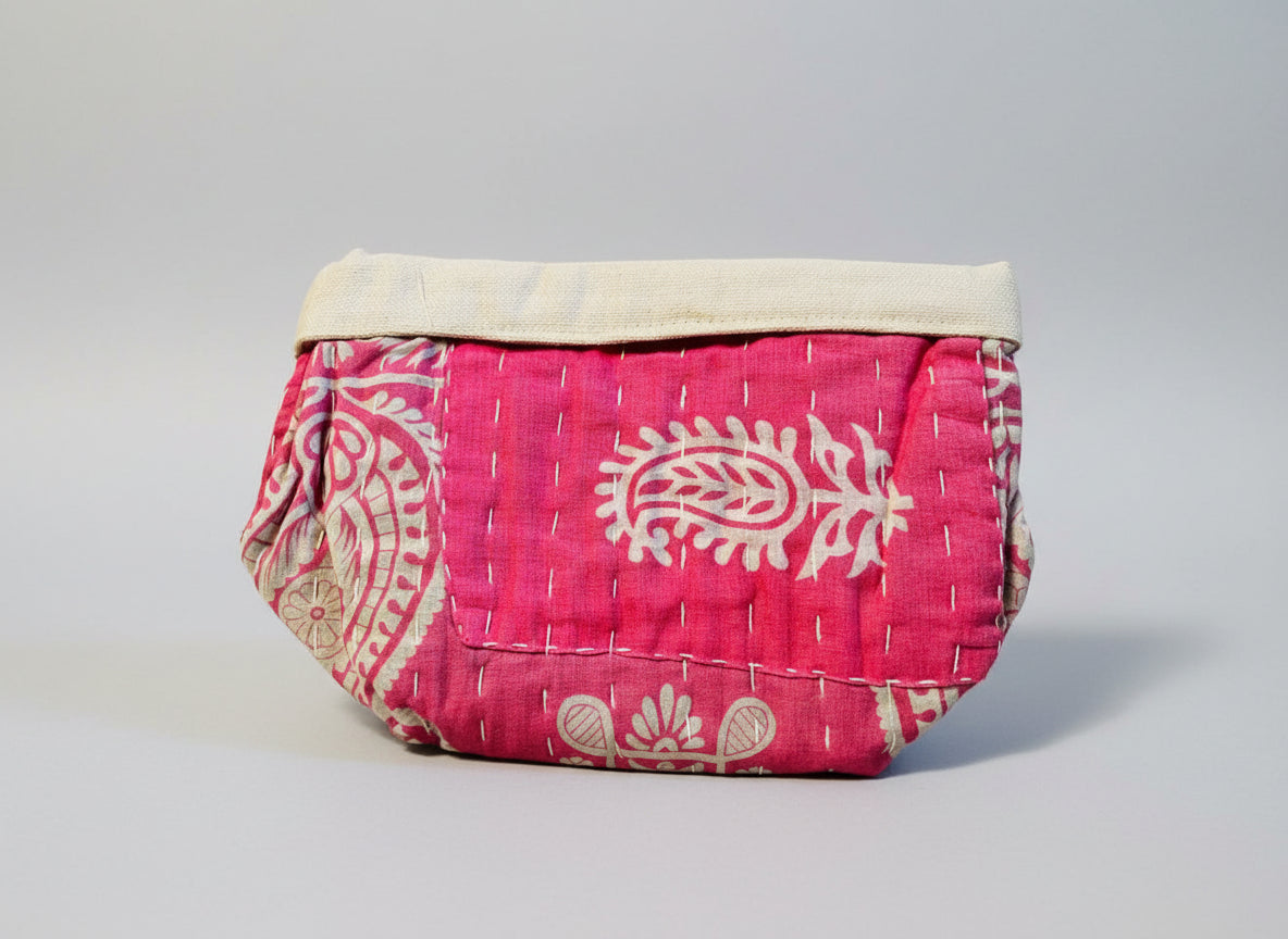 Pink and floral Kantha basket on a neutral background.