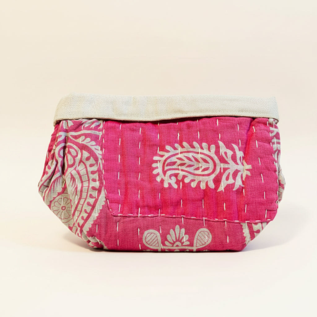 Pink and floral Kantha basket on a neutral background.