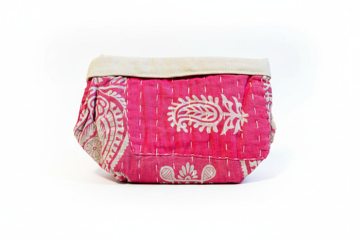 Pink and floral Kantha basket on a neutral background.