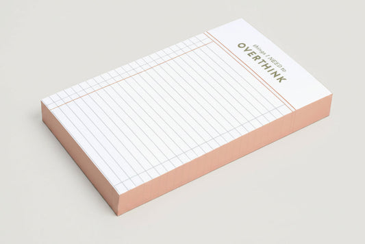 Grid notepad with 'things I Need to Overthink' statement on a white background