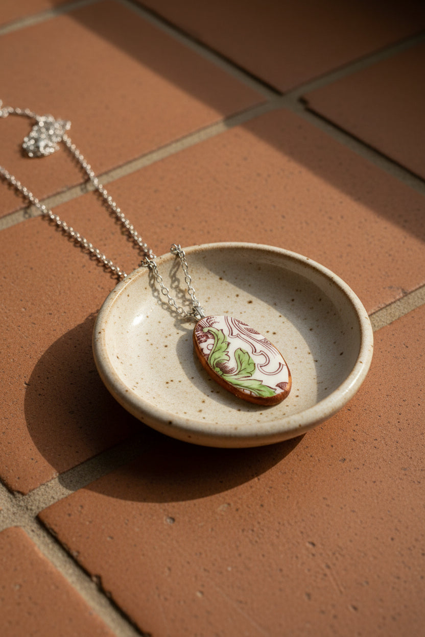 Necklace with a decorative pendant on a plain background
