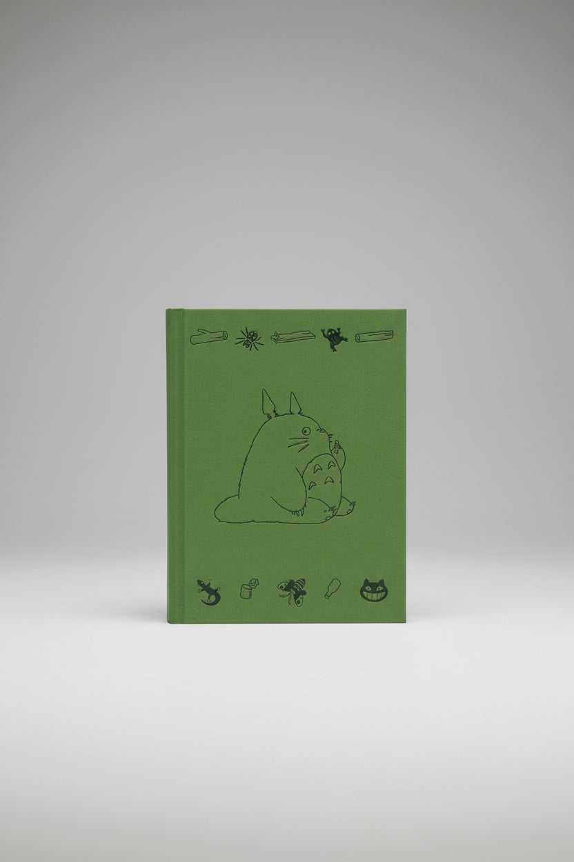 Green Totoro book cover with black line art of a character and various small illustrations on a white background