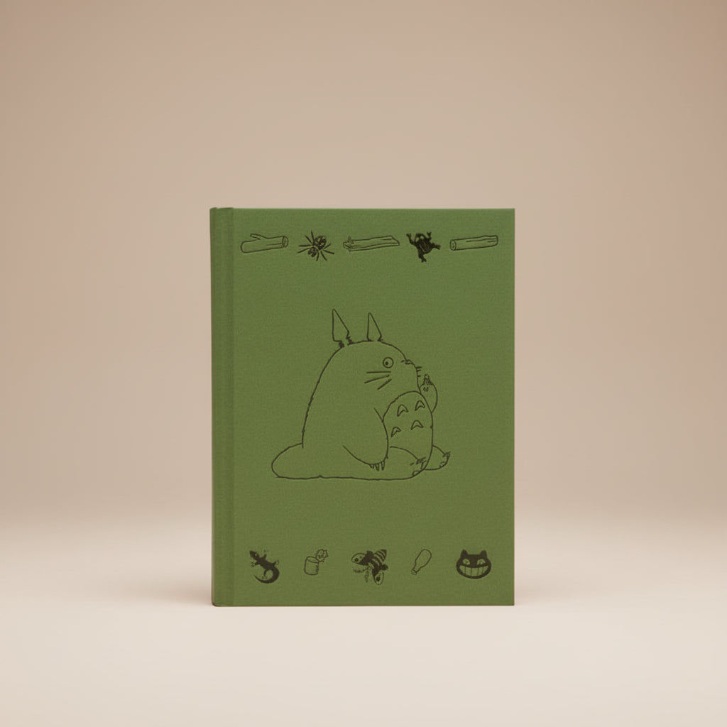 Green Totoro book cover with black line art of a character and various small illustrations on a white background