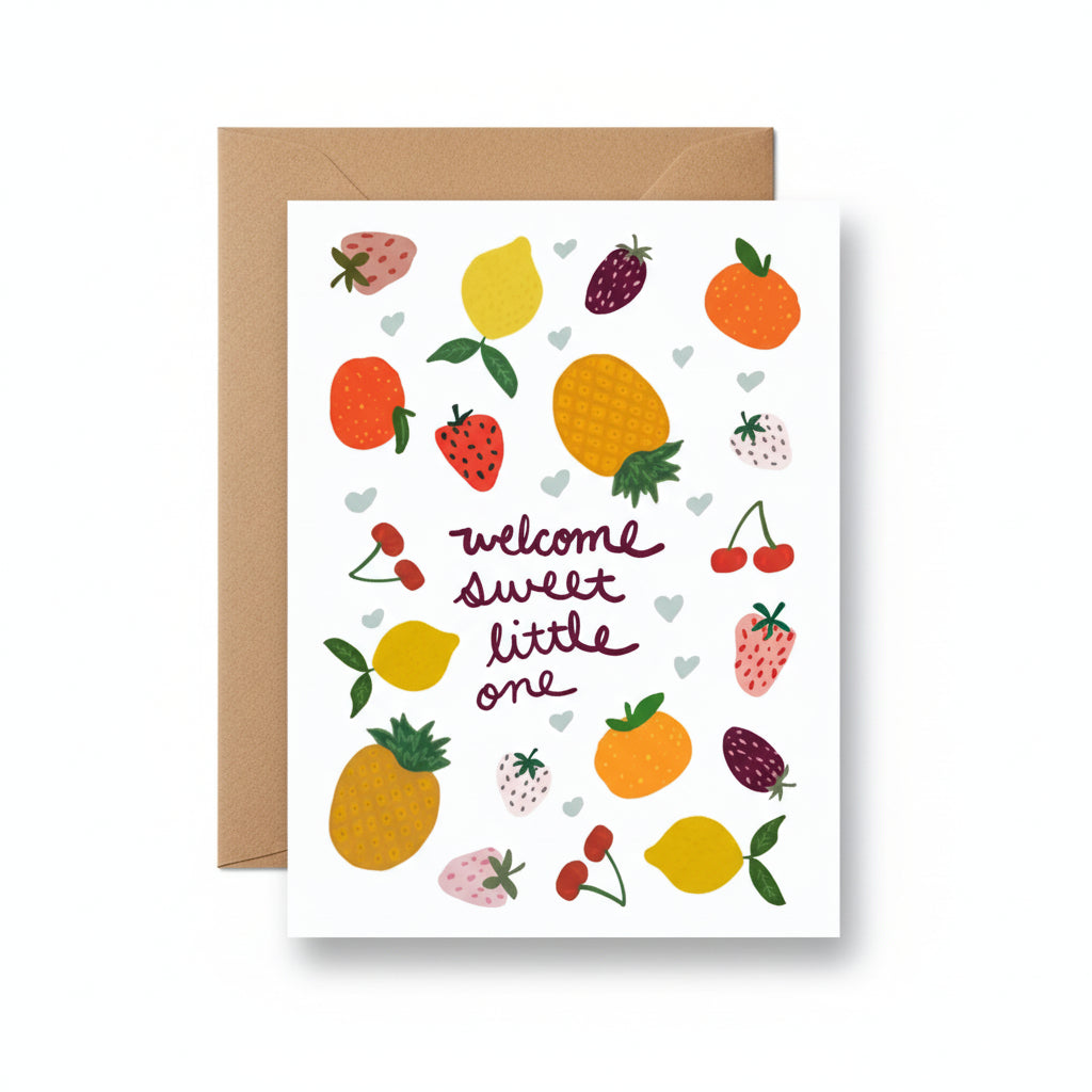 A hand illustrated card with fruit that states, 'Welcome Sweet Little One' with a kraft envelope on a white background.
