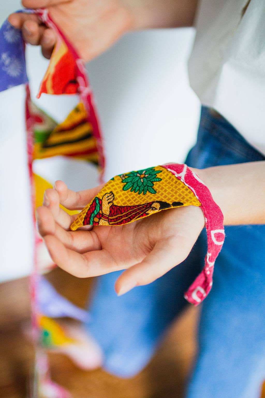 Folded view of the triangle banner showing handmade stitching and sari texture detail