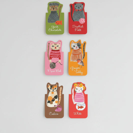 Close-up of illustrated feline designs with unique facial expressions