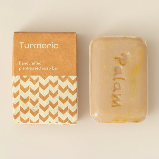 Turmeric soap bar with packaging on a white background