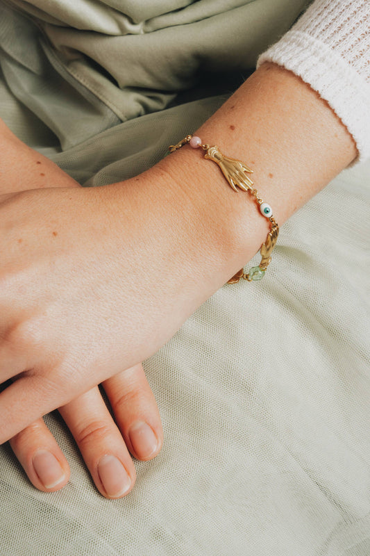 Delicate charm bracelet styled with a linen dress and dainty rings