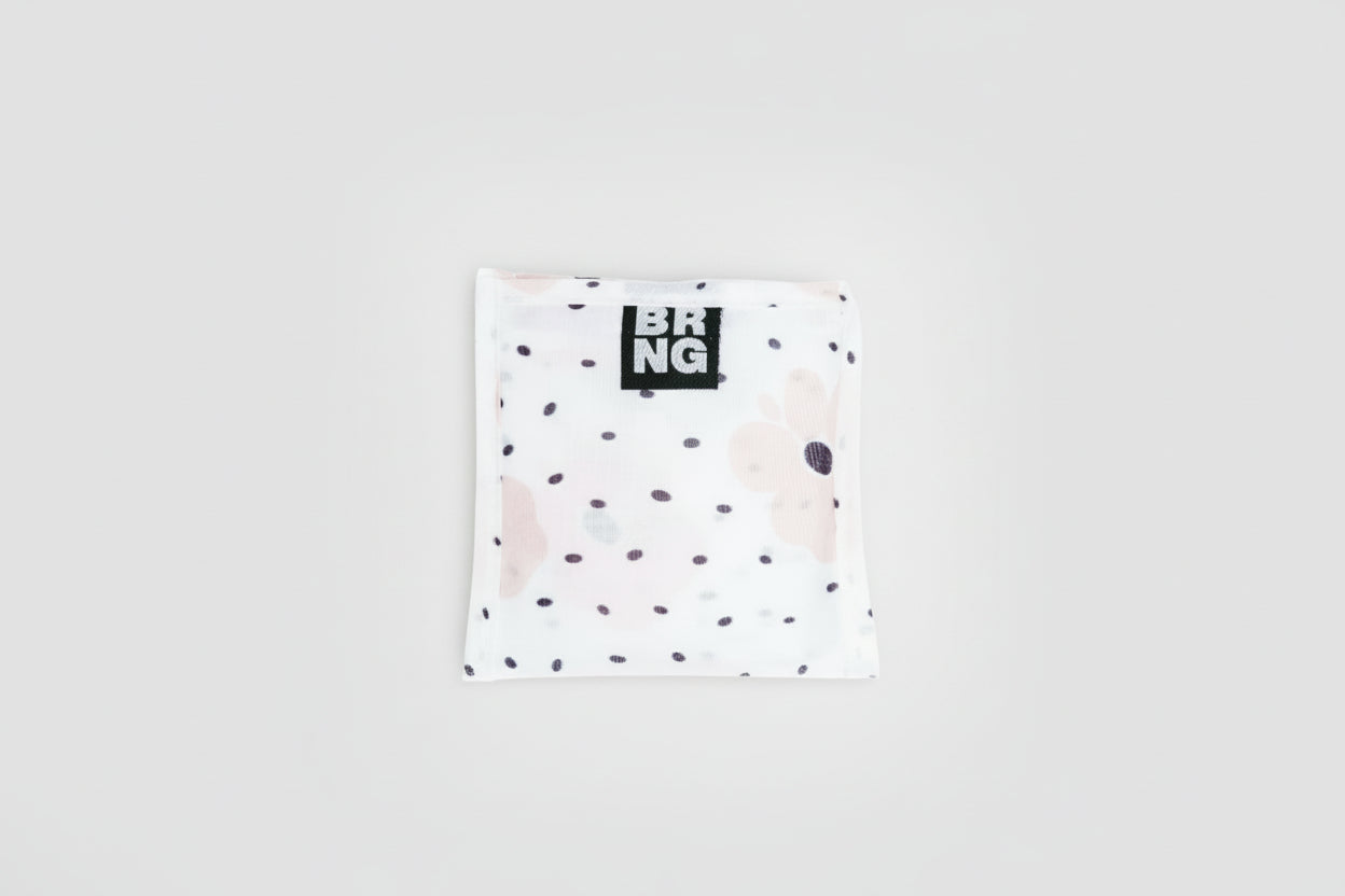 BRNG Carley Daily Shopper Mini bag with blush poppies and black polka dots folded into a compact size on a white background.