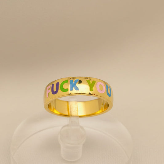 Gold ring with colorful letters spelling 'FUCK YOU' on a white background