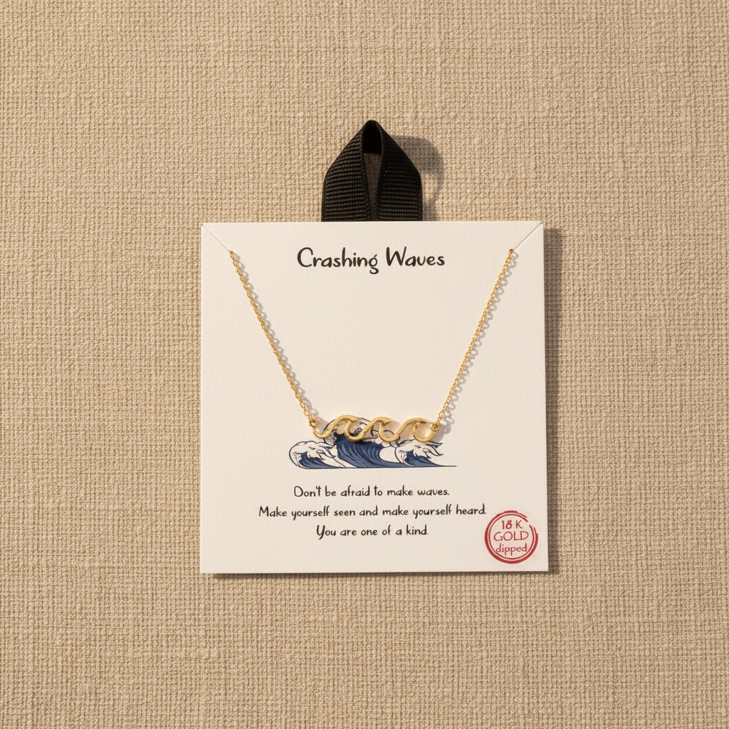 18 K gold dipped necklace with wave design on a branded card with text and gold stamp.