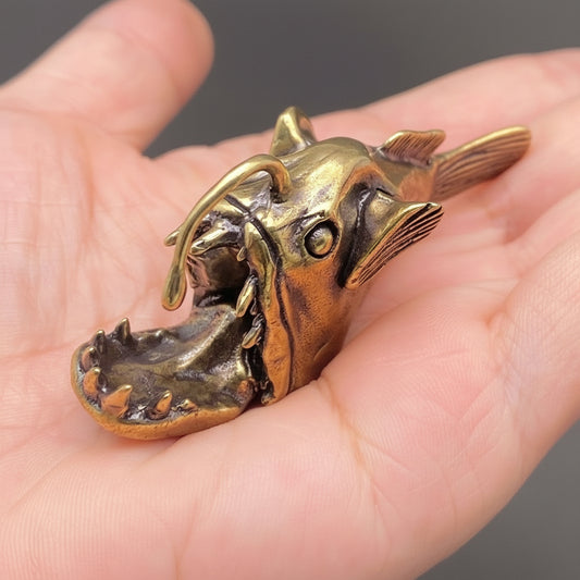 Bronze Anglerfish being held in a person's hand.